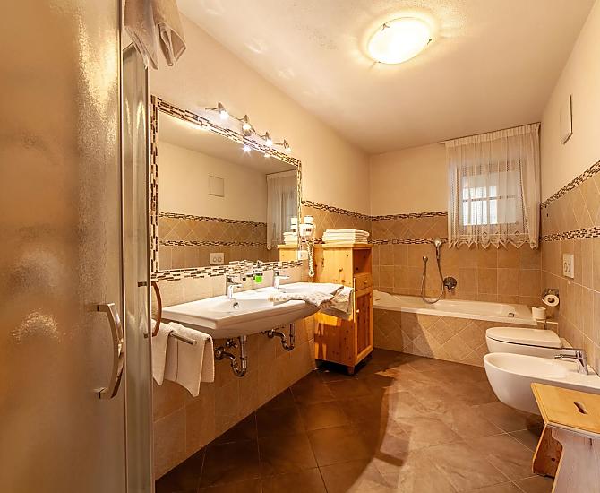Dusche und Badewanne, zwei Waschbecken und ein Bidet