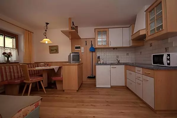 Die Wohnküche verfügt über eine Elektroplatte, eine Mikrowelle, einen Kühlschrank, eine Kaffeemaschine, einen Toaster und Geschirr.