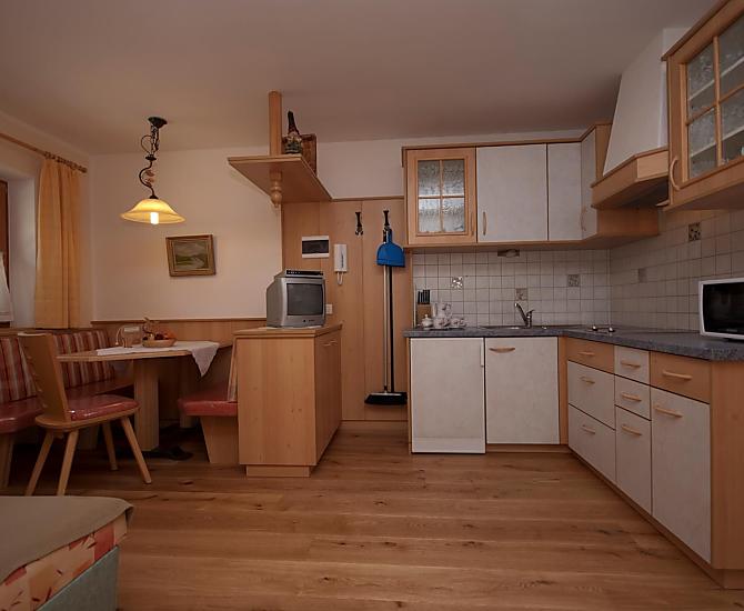 Die Wohnküche verfügt über eine Elektroplatte, eine Mikrowelle, einen Kühlschrank, eine Kaffeemaschine, einen Toaster und Geschirr.